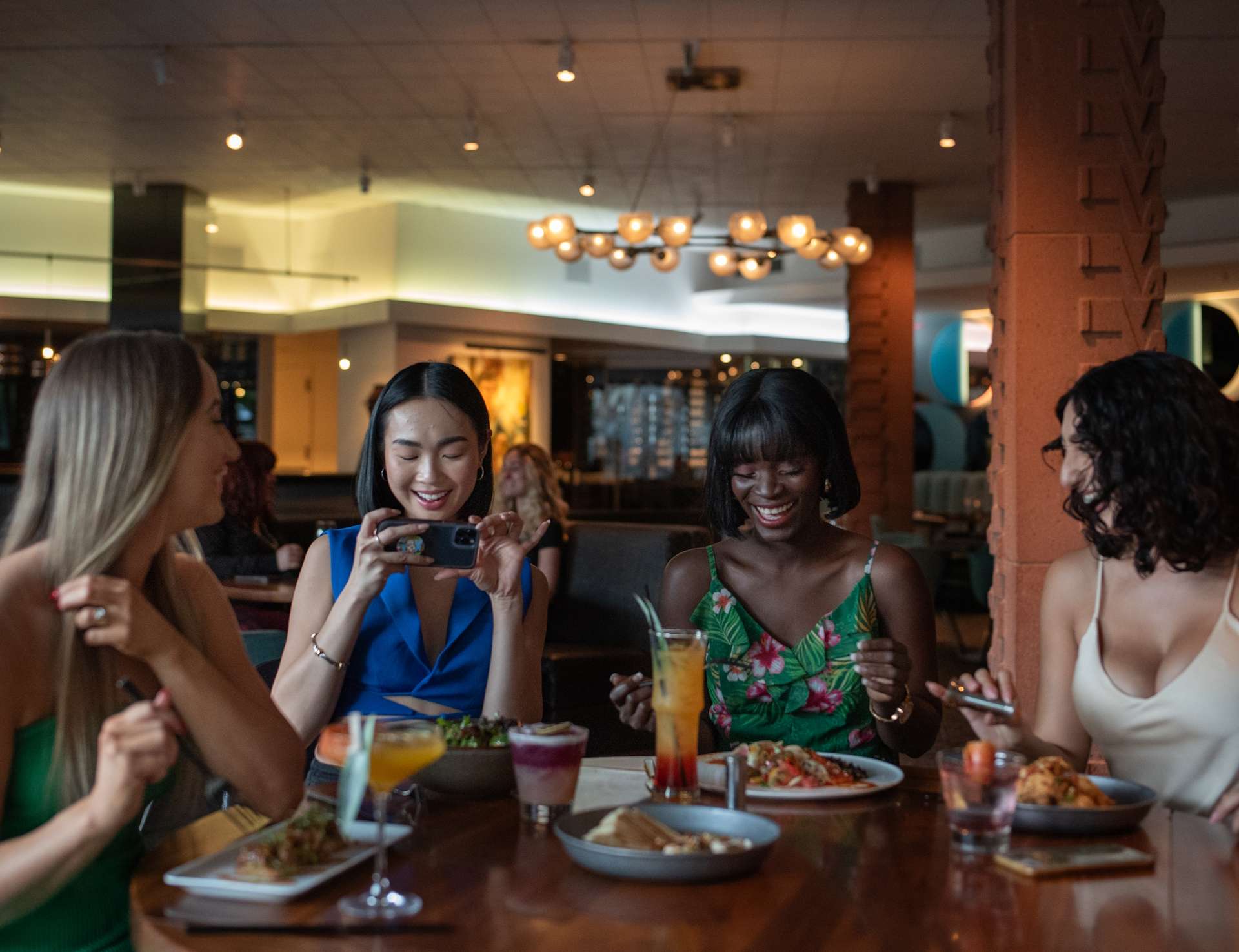 Four women enjoying food and drinks at Hotel Valley Ho.