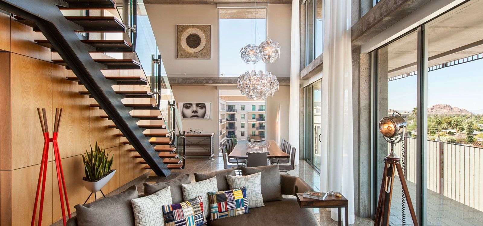 The Presidential Loft featuring a couch, stairs, and long table.