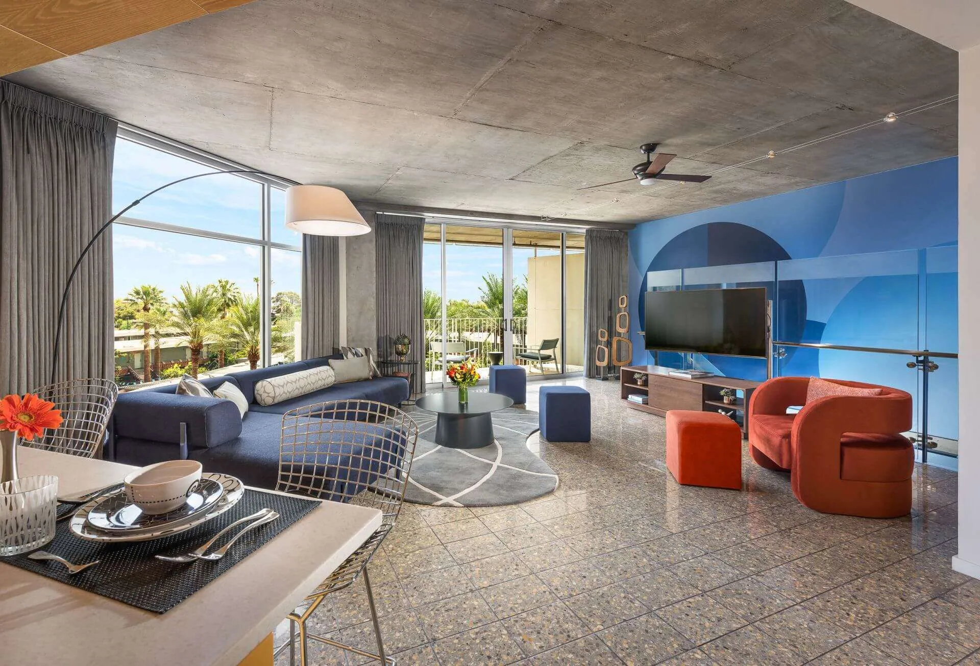 The Tower Loft featuring a circular table, multiple chairs, and a TV at the wall.