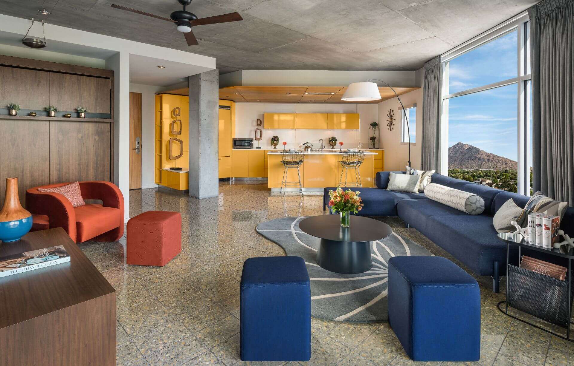 The Tower Loft featuring a circular table, multiple chairs, and a large window.