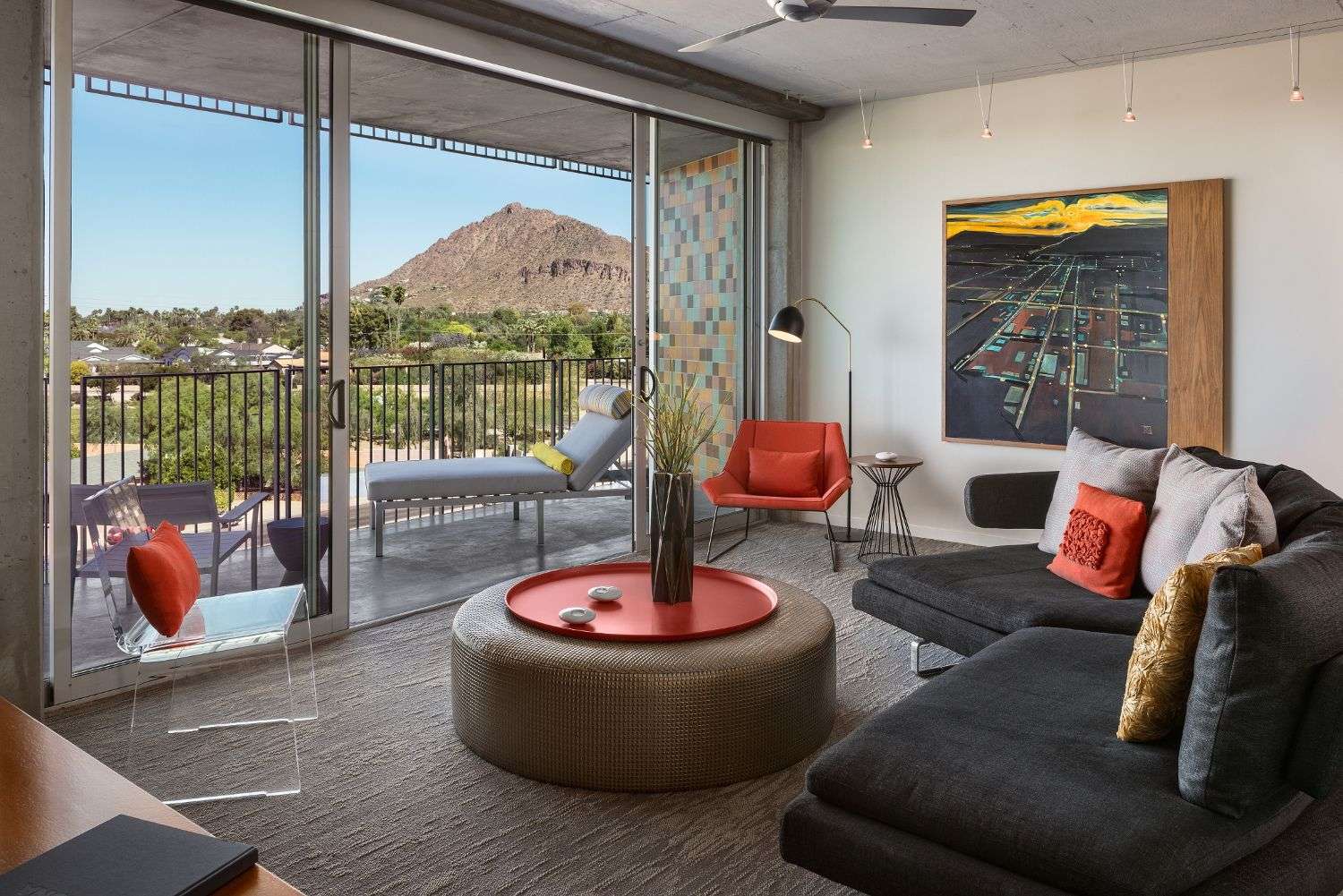A room featuring a circular table, couch, and sliding door that leads to the balcony.