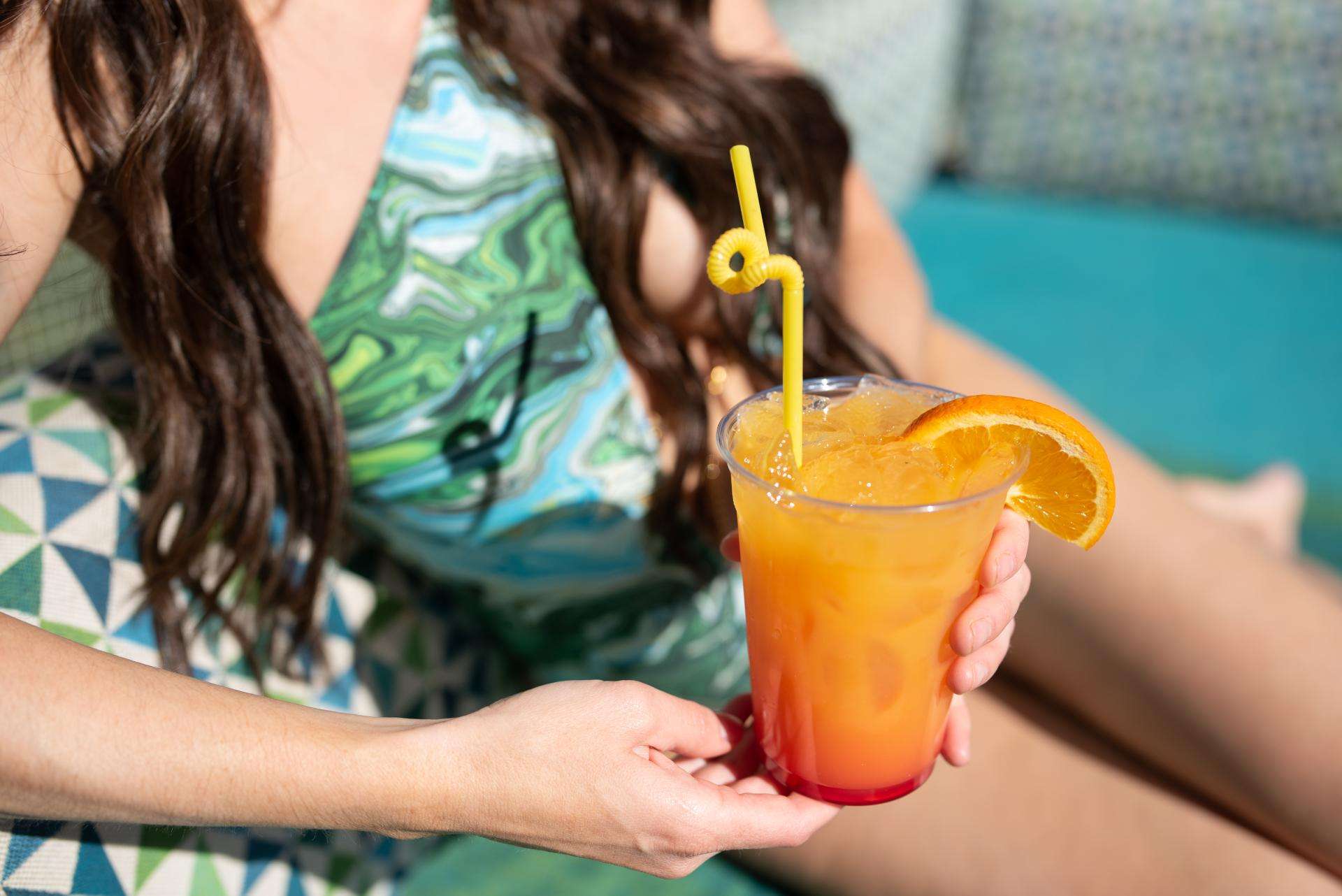 Woman in bikini enjoying a drink at Hotel Valley Ho.