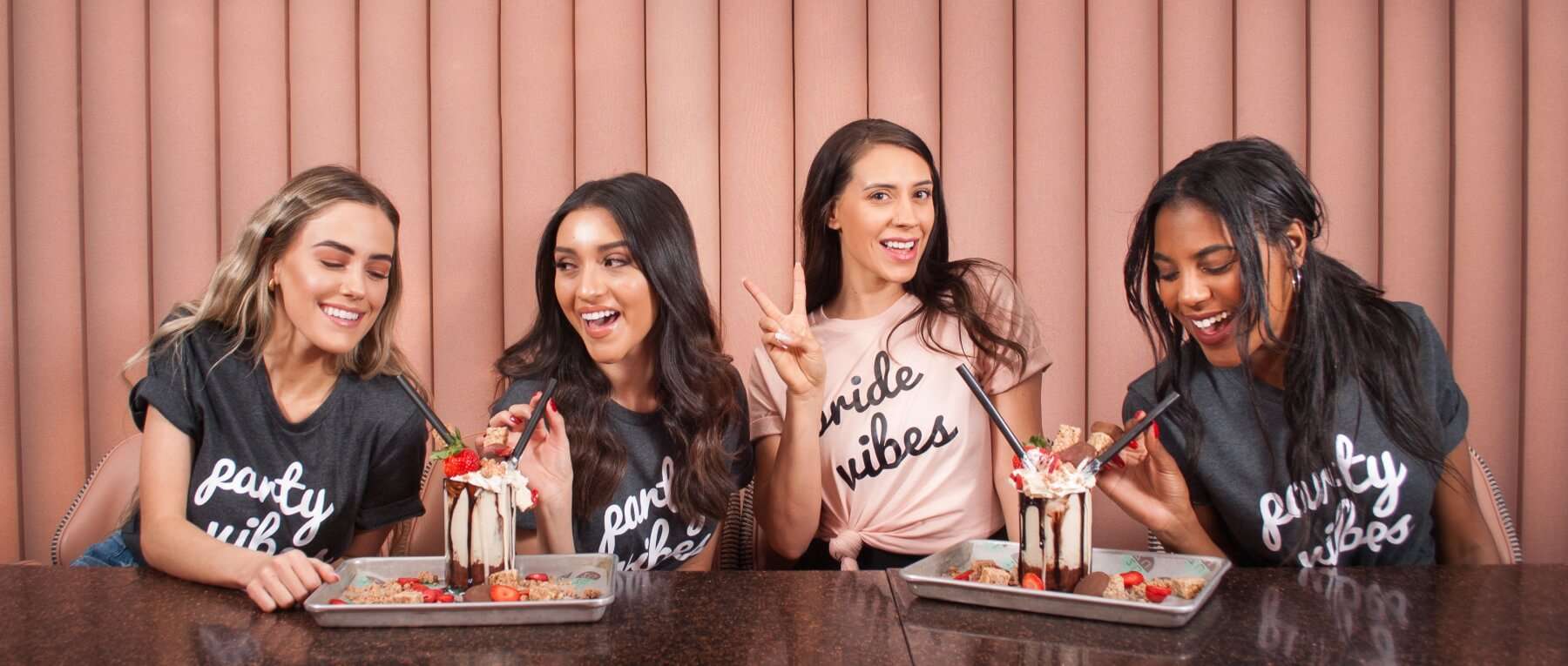 Bachelorette party group of four women enjoying over-the-top milkshakes.