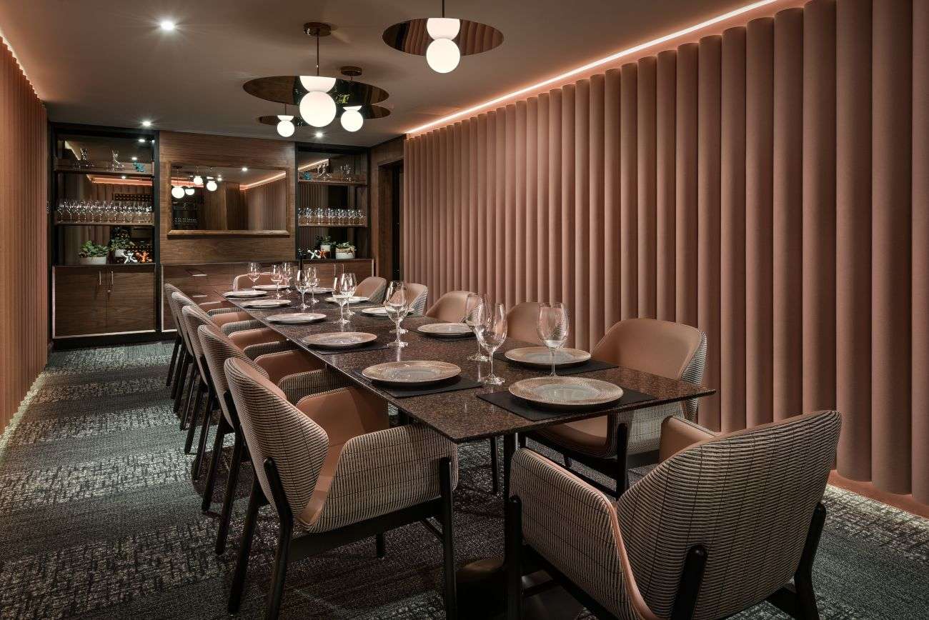 A board room featuring a long table surrounded by multiple chairs