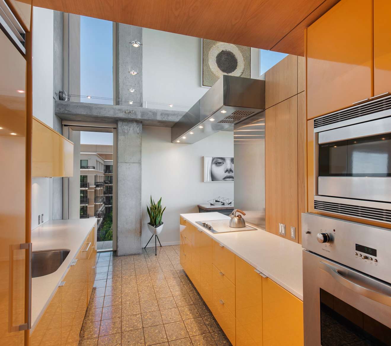 Bright kitchen featuring a sink, oven, and window.