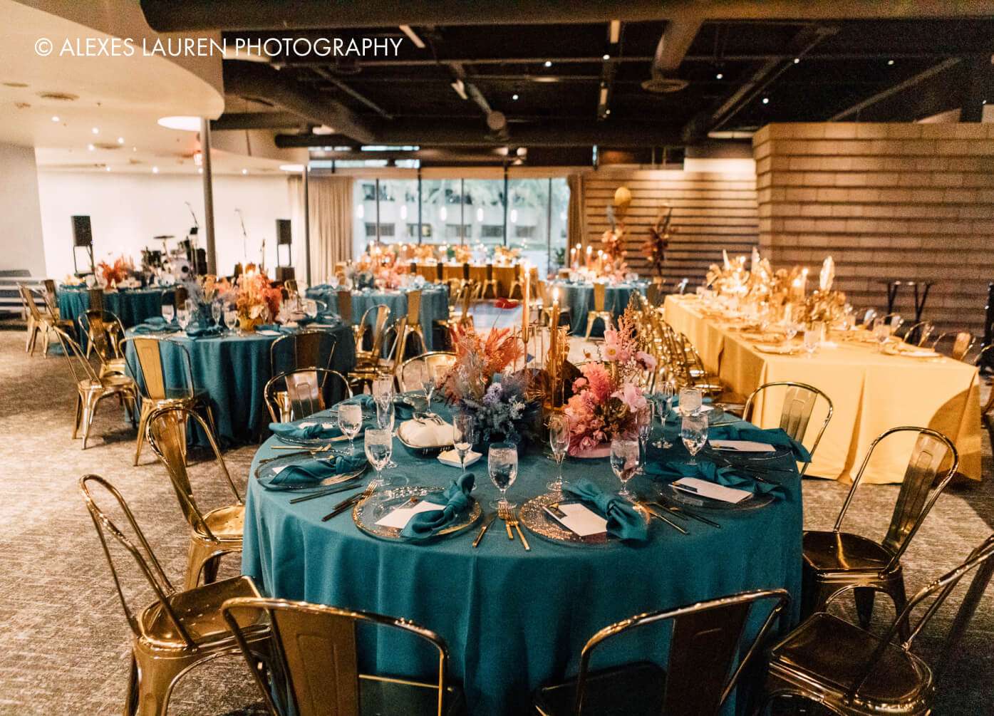 Elegant wedding reception with blue and gold decor.