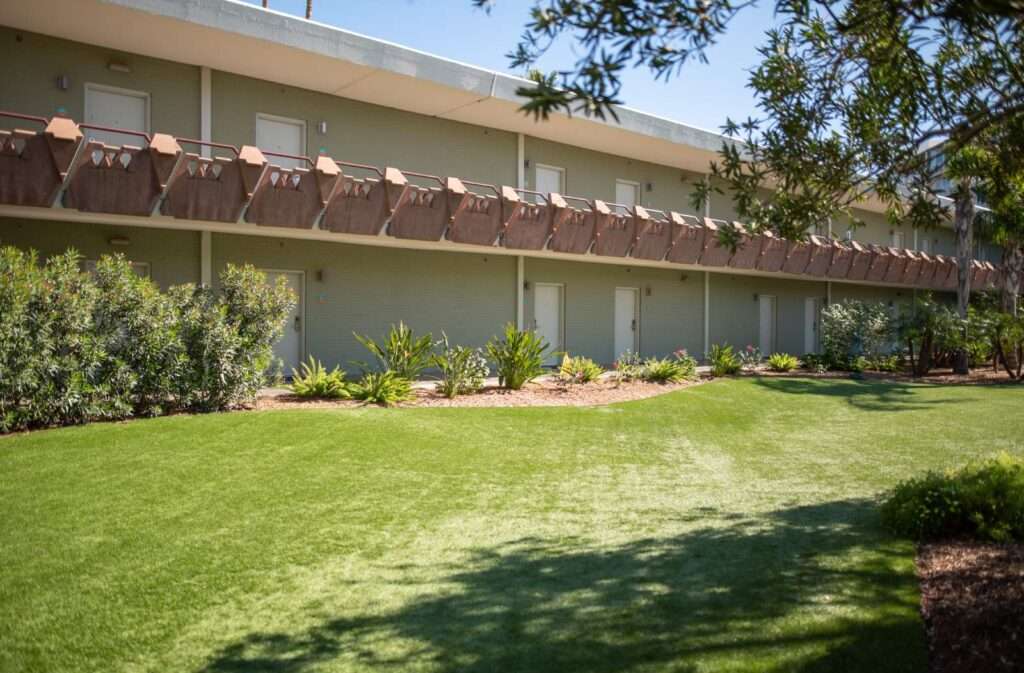 Hotel Valley Ho balcony overlooking grassy area and tree.