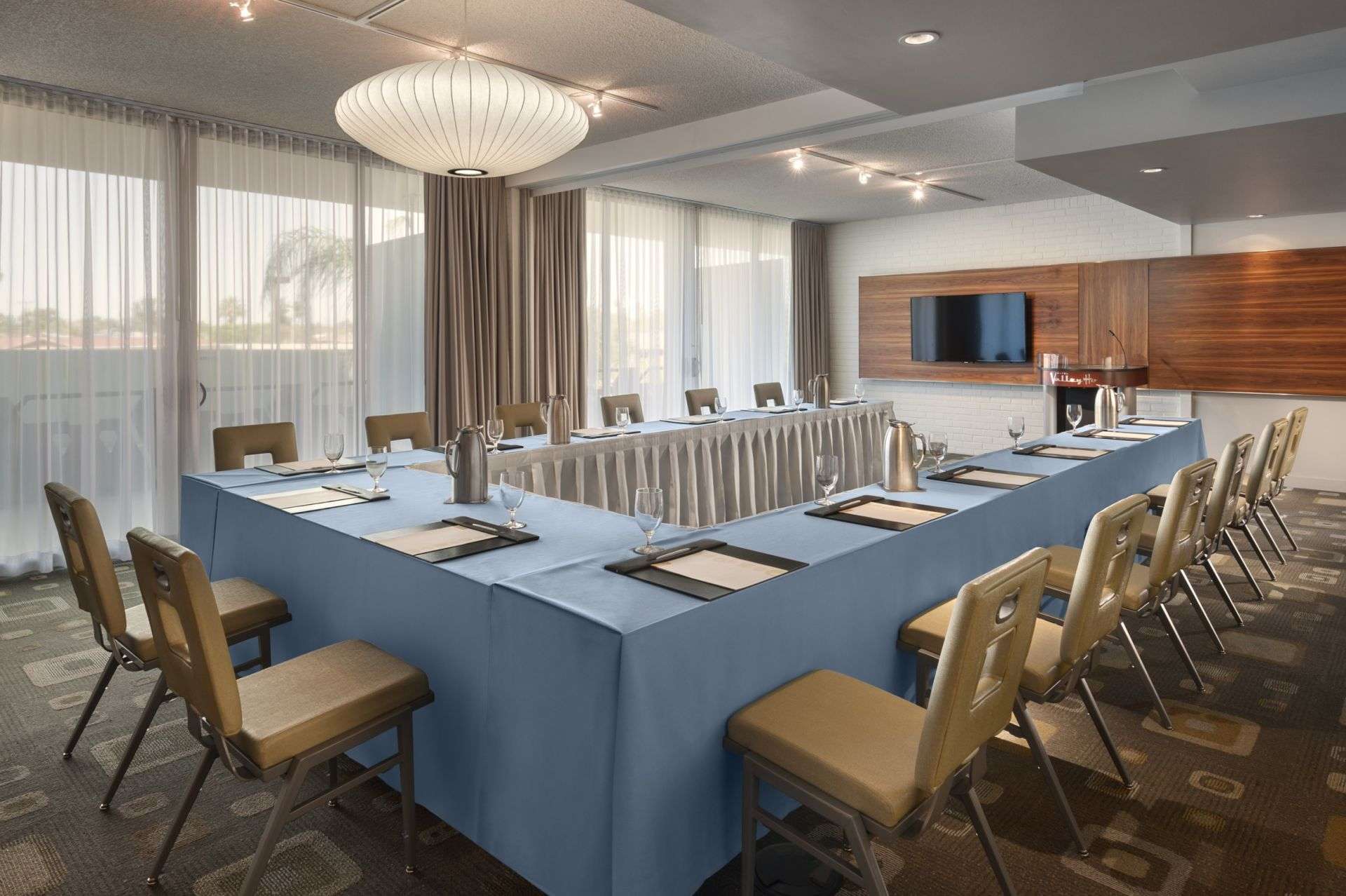 Spacious conference room featuring a long table and chairs.