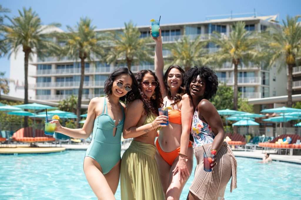 four women at OH Pool with cocktails