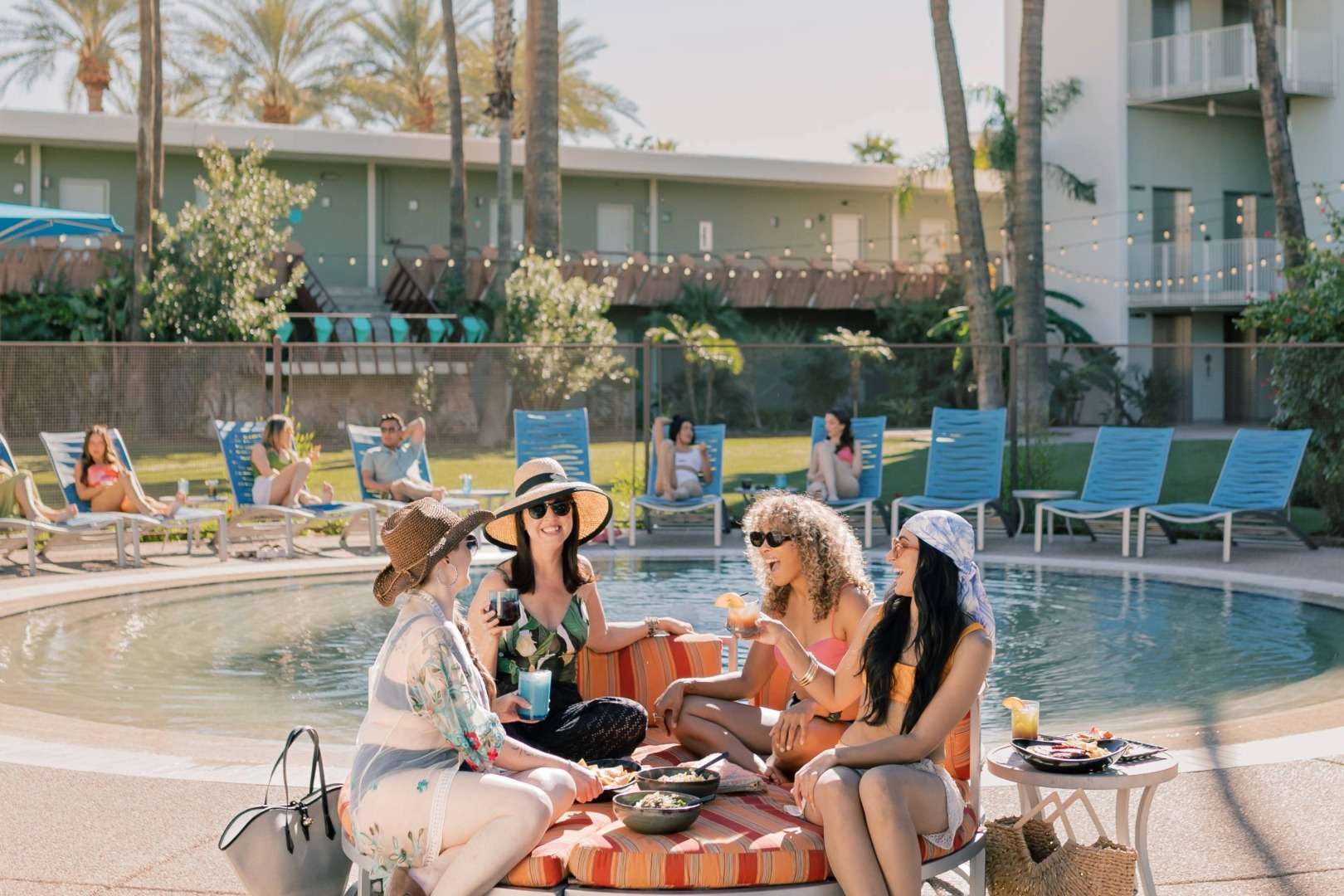 Four Women Lounging at OHasis Pool