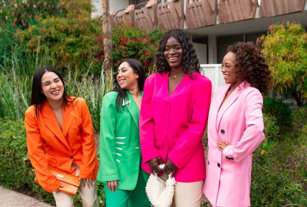 four women in colorful suits