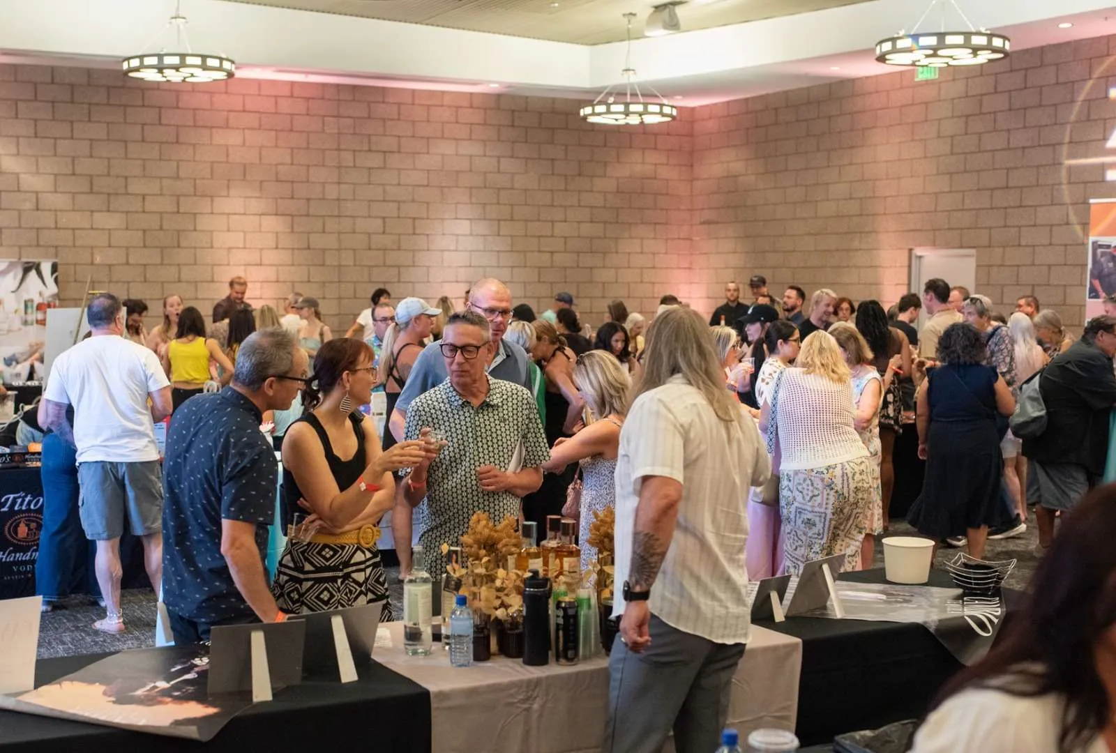 people shopping, sipping and sampling at the indoor market